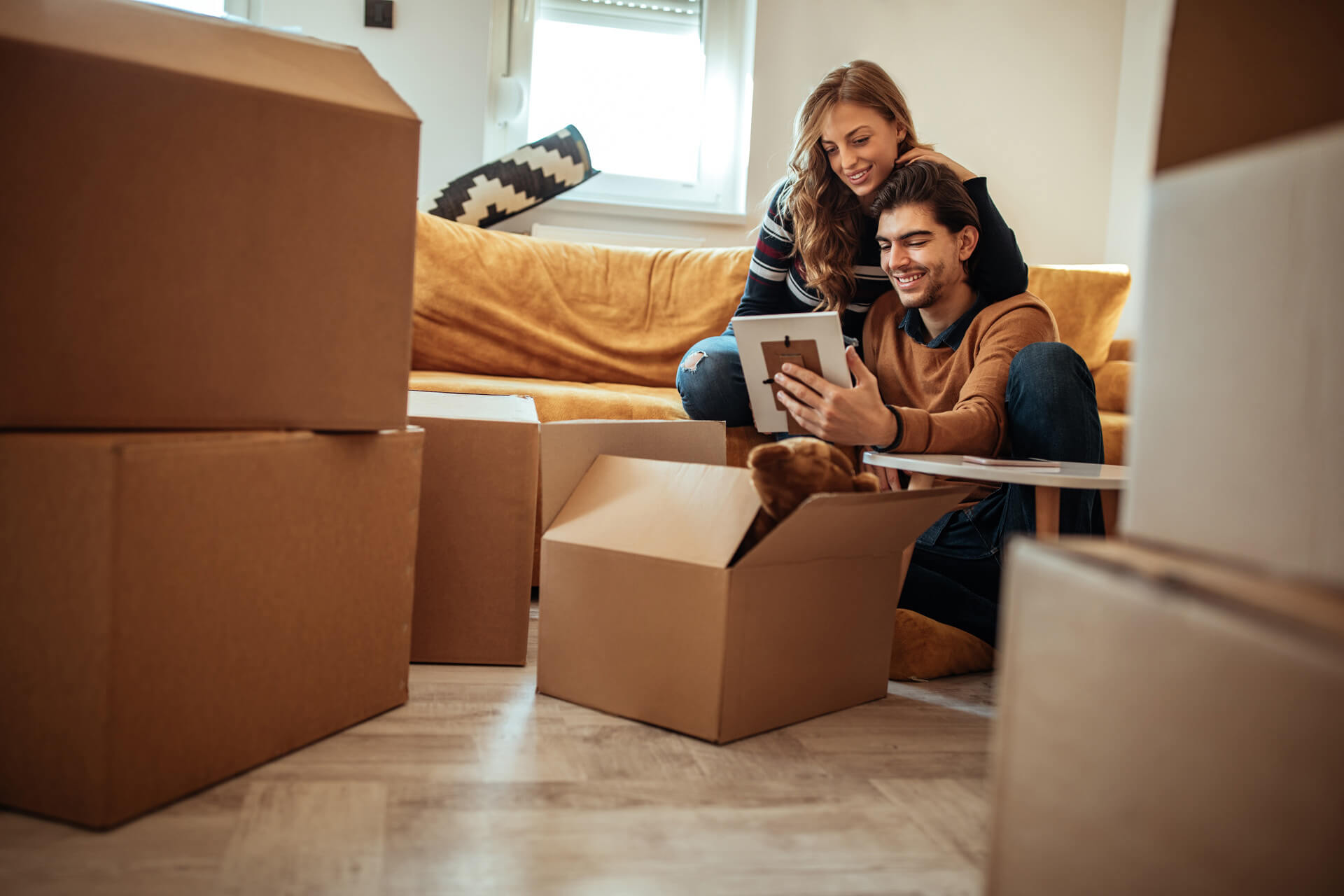 Shot of a young couple moving into their new home